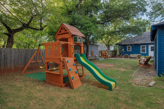 view of jungle gym with an outdoor living space and a lawn