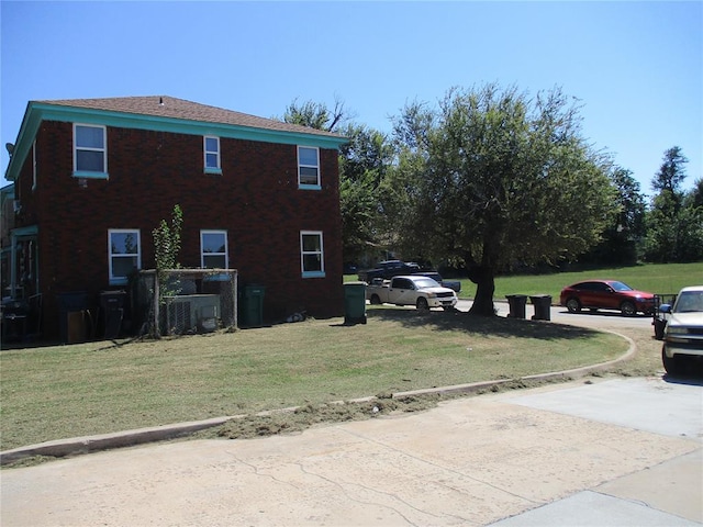 view of side of home with a yard