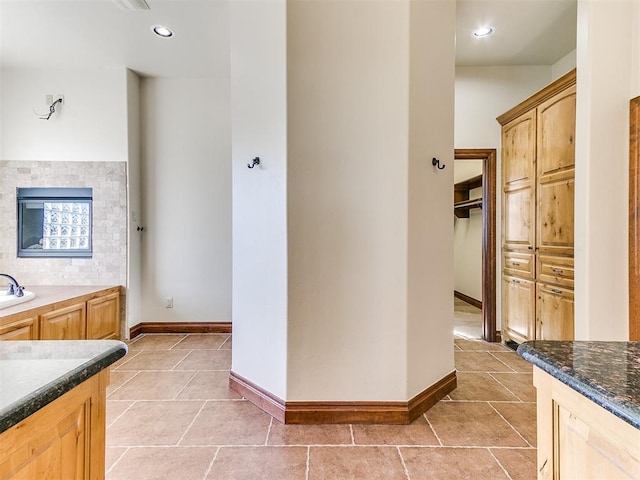 bathroom featuring vanity, tile patterned floors, and a bathing tub