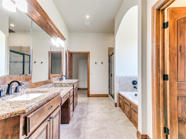 bathroom featuring tile patterned flooring, vanity, and separate shower and tub