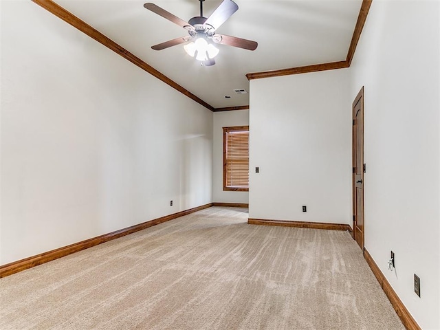 empty room featuring light carpet, ceiling fan, and ornamental molding