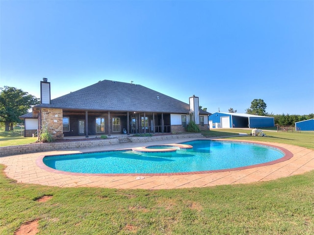 view of swimming pool with a lawn, an in ground hot tub, and a patio