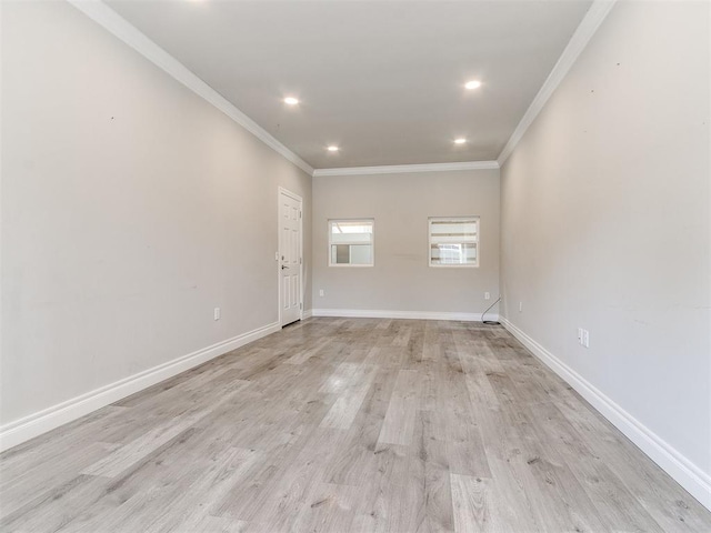 spare room featuring crown molding and light hardwood / wood-style flooring