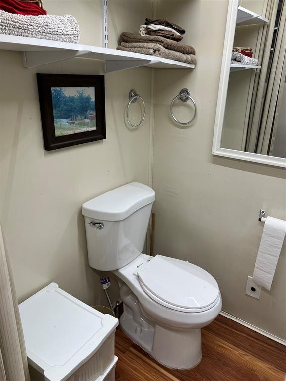 bathroom featuring hardwood / wood-style floors and toilet