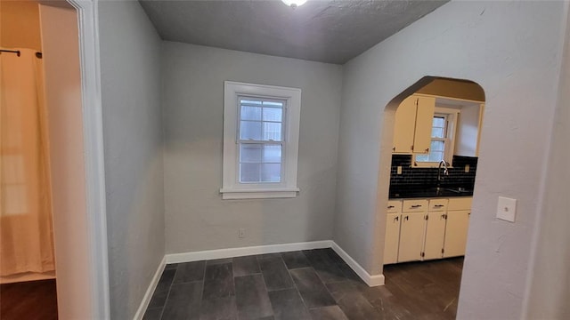 hall featuring sink and dark wood-type flooring