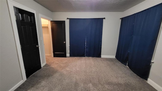 bedroom with carpet flooring, a textured ceiling, and a closet