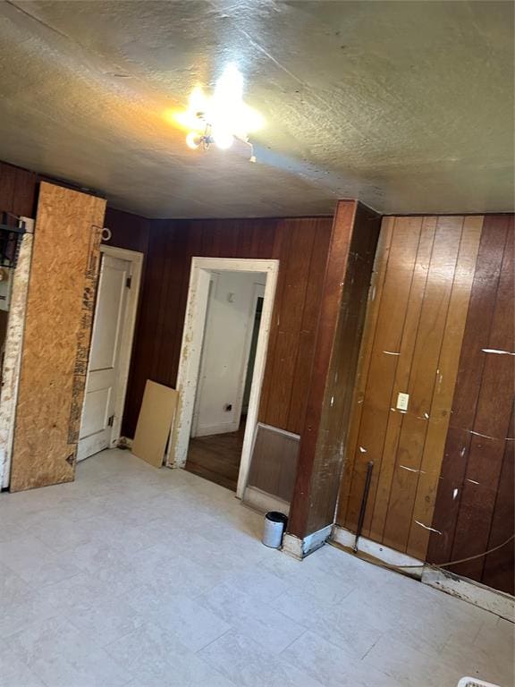 spare room with wood walls