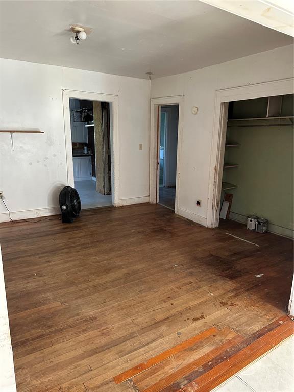 unfurnished bedroom featuring a closet and wood-type flooring