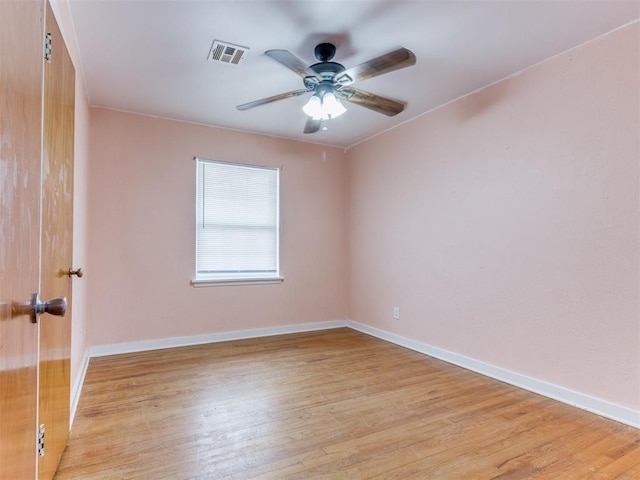 unfurnished room with light wood-style floors, baseboards, and visible vents