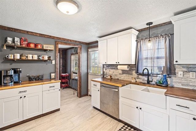 kitchen with butcher block countertops, dishwasher, white cabinets, and decorative light fixtures