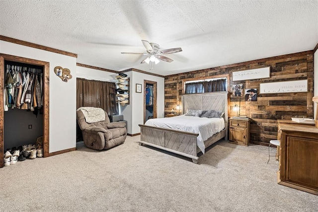 bedroom featuring wood walls, ceiling fan, and light carpet