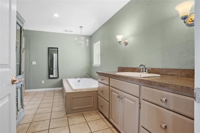 24484 E 990th Rd, Weatherford, OK 73096 - bathroom featuring a tub to relax in, tile patterned flooring, vanity, and an inviting chandelier