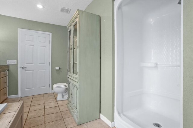 24484 E 990th Rd, Weatherford, OK 73096 - bathroom featuring tile patterned flooring, vanity, toilet, and walk in shower