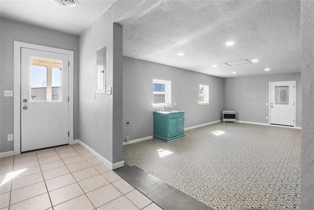 24484 E 990th Rd, Weatherford, OK 73096 - tiled foyer entrance with heating unit, sink, and a textured ceiling
