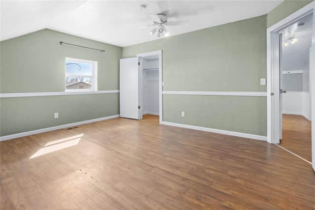24484 E 990th Rd, Weatherford, OK 73096 - unfurnished bedroom featuring vaulted ceiling, ceiling fan, a spacious closet, hardwood / wood-style floors, and a closet