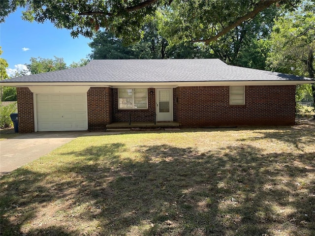 ranch-style home featuring a garage and a front lawn