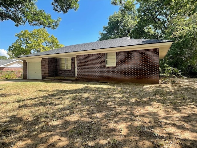 exterior space featuring a garage and a front yard