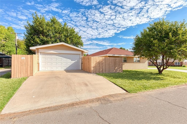 view of front of property featuring a garage and a front lawn