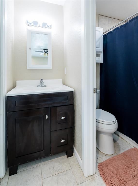 bathroom featuring ceiling fan, tile patterned flooring, vanity, and toilet