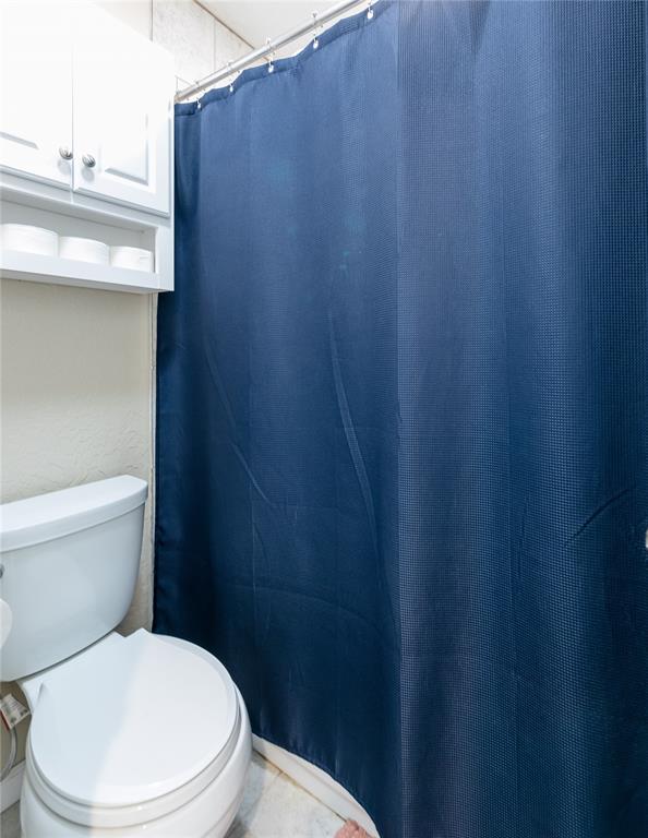 bathroom featuring tile patterned floors and toilet