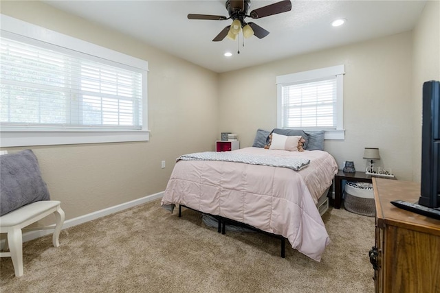 bedroom with ceiling fan and light carpet