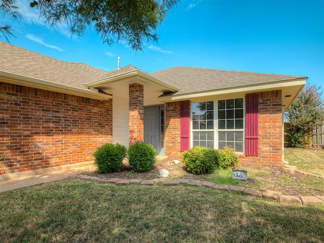 doorway to property featuring a lawn