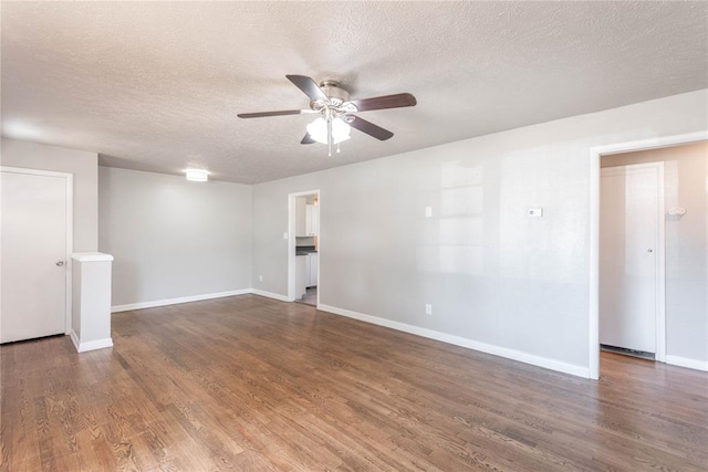 unfurnished room featuring a textured ceiling, ceiling fan, and dark hardwood / wood-style floors