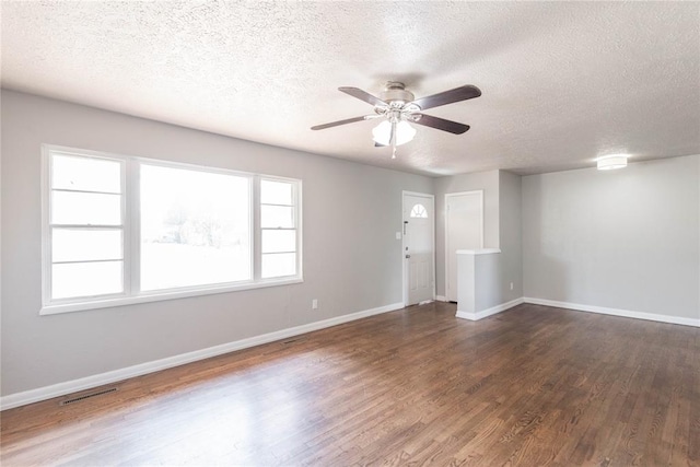 unfurnished room featuring a textured ceiling, dark hardwood / wood-style flooring, and ceiling fan