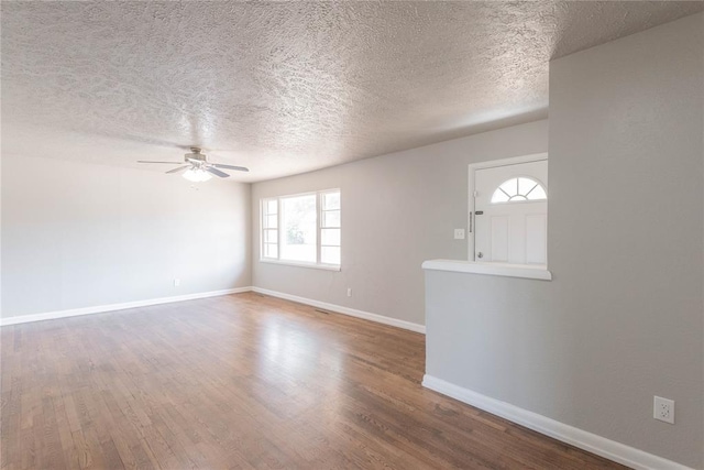 interior space featuring ceiling fan, hardwood / wood-style floors, and a textured ceiling