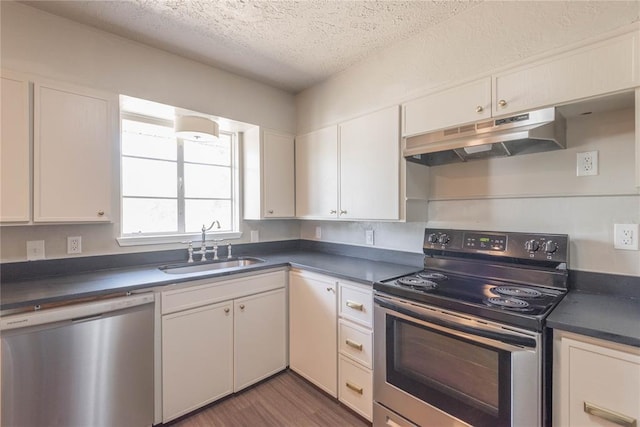 kitchen with sink, white cabinets, stainless steel appliances, and a textured ceiling