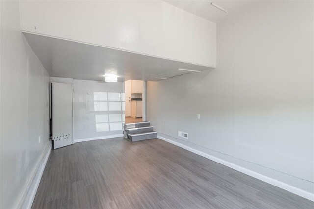 unfurnished living room with dark hardwood / wood-style flooring