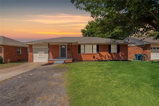 ranch-style home with a yard