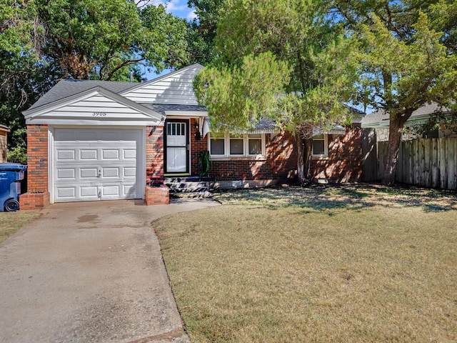 view of front of home with a front yard and a garage