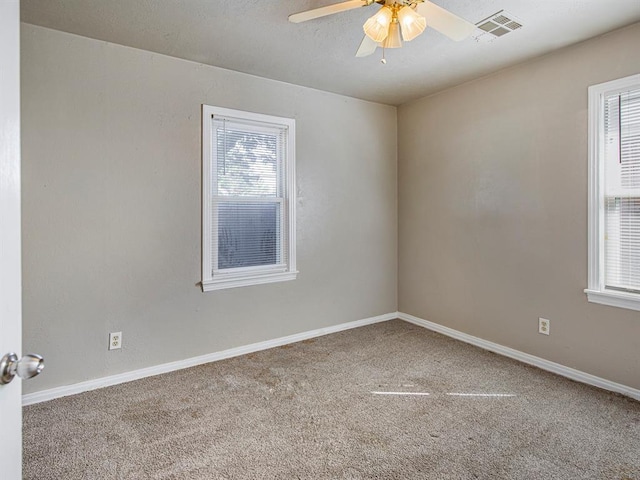 spare room featuring ceiling fan and carpet