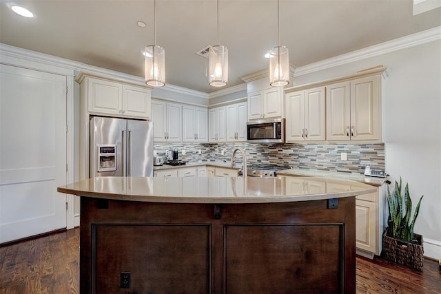 kitchen featuring appliances with stainless steel finishes, ornamental molding, hanging light fixtures, and dark wood-type flooring