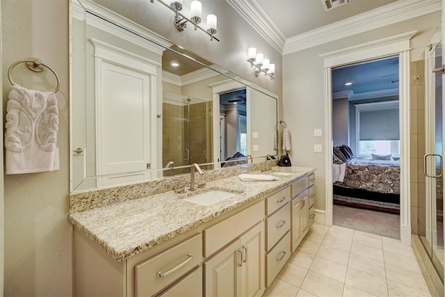 bathroom featuring tile patterned flooring, vanity, a shower with door, and ornamental molding