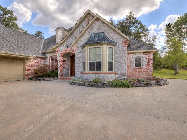 french country style house featuring a garage