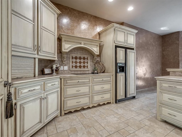 kitchen with black electric stovetop, paneled built in fridge, backsplash, and cream cabinets