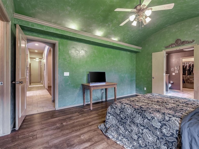 bedroom featuring ceiling fan, crown molding, vaulted ceiling, and hardwood / wood-style flooring