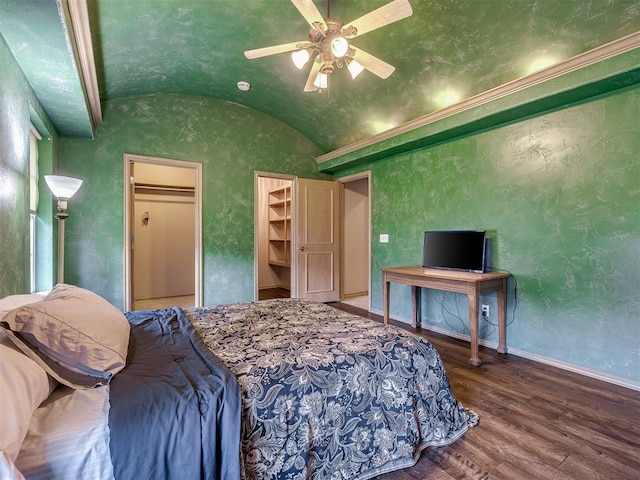 bedroom featuring hardwood / wood-style floors, ceiling fan, a spacious closet, and vaulted ceiling