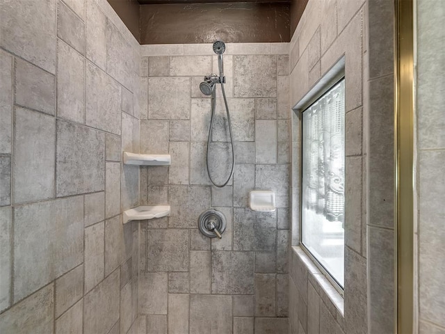 bathroom with tiled shower