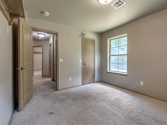 unfurnished bedroom with light carpet