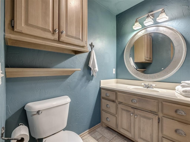 bathroom with tile patterned floors, vanity, and toilet