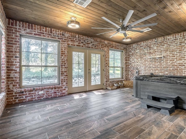 interior space featuring ceiling fan, french doors, wooden ceiling, brick wall, and dark hardwood / wood-style floors