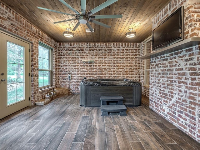 interior space with a jacuzzi, wood-type flooring, ceiling fan, and wooden ceiling