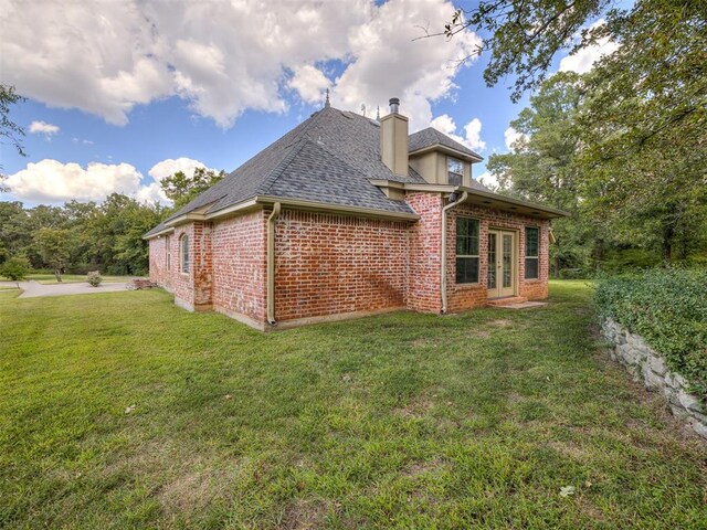 back of house with a lawn and french doors