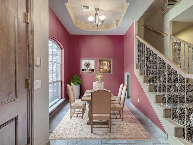 dining room featuring an inviting chandelier and a tray ceiling