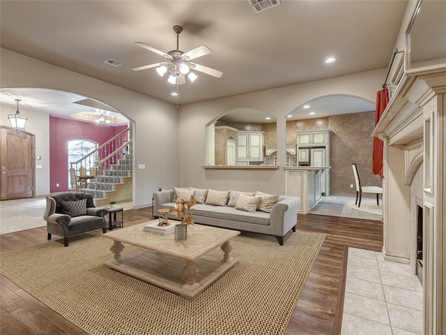 living room with ceiling fan and light wood-type flooring