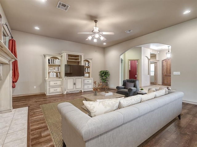 living room with hardwood / wood-style flooring and ceiling fan