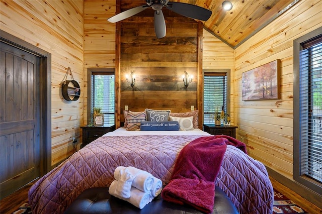 bedroom with ceiling fan, wood walls, wood-type flooring, lofted ceiling, and wood ceiling